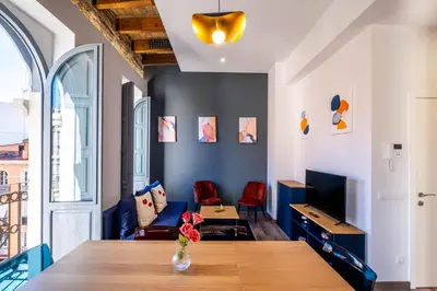 a living room with a table and a couch at BrightHouse with Warm and Friendly Vibes in Valencia