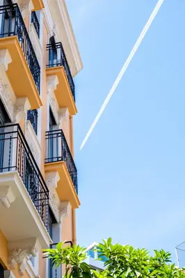 a tall apartment building with balconies and trees at Beautifully Designed Studio with Lots of Natural Light in Valencia
