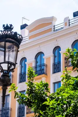 a yellow building with blue windows and a street light at Beautifully Designed Studio with Lots of Natural Light in Valencia