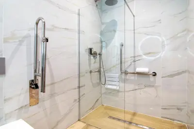 a shower with a glass door in a bathroom at VLC Host - Cubells Apartments in Valencia