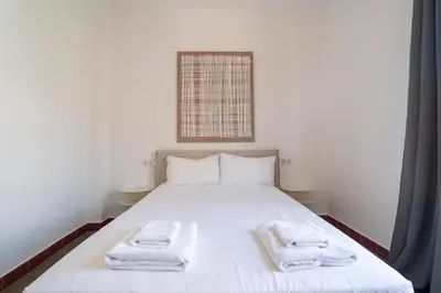 a bedroom with a bed with towels on it at VLC Host - Cubells Apartments in Valencia