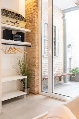 a living room with a sliding glass door at ApartUP Las Arenas Beach in Valencia