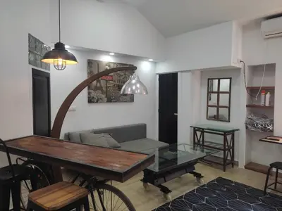 a living room with a table and a bike in it at Loft puerto de Valencia in Valencia