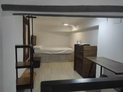 a bedroom with a bed and a desk and a ladder at Loft puerto de Valencia in Valencia