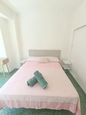 a bedroom with a bed with two pillows on it at Apartamento Lyon in Cullera
