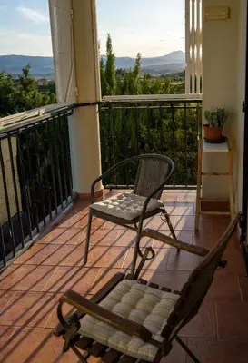 a chair and a bench on a balcony at Beautiful Villa with huge private pool and vineyard view in Valencia