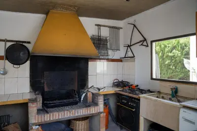 a kitchen with a stove top oven and a sink at Beautiful Villa with huge private pool and vineyard view in Valencia