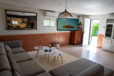 a living room with a couch and a table at Beautiful Villa with huge private pool and vineyard view in Valencia