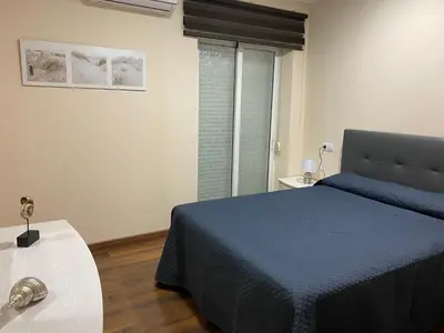 a bedroom with a blue bed and a window at La Andana in Macastre