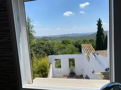 a window with a view of a white house at La Andana in Macastre