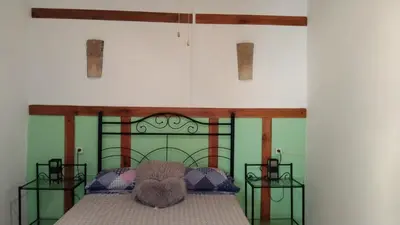 a bedroom with a bed with a teddy bear on it at Casa de pueblo García Marquez in Geldo