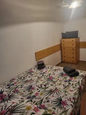 a bedroom with a bed and a dresser at carrer de la pau port de sagunto in Valencia