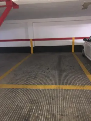 a parking garage with a car parked in it at Apartamento 100 metros Playa San Antonio CULLERA in Cullera