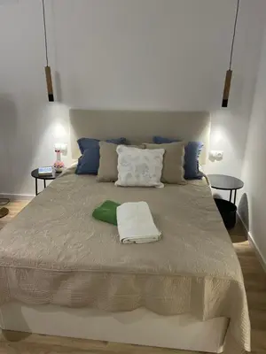a large bed in a room with two tables at Carbonell by VivoGCFlats in Valencia
