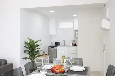 a kitchen with a table with a bowl of fruit on it at SingularStays Cullera V in Cullera