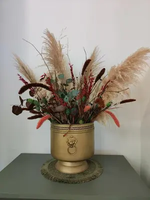 a vase with feathers in it on a table at Las Artes Hlius Luxury Apartments in Valencia