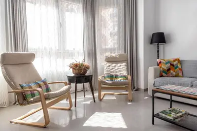 a living room with chairs and a couch and a table at Vilamercat in Sueca