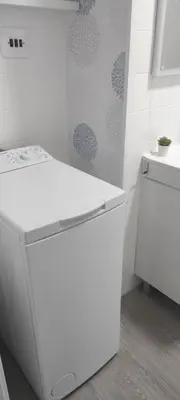 a white kitchen with a sink and a dishwasher at El Cisne frente al mar- Piscina y Wifi in Cullera