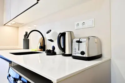 a kitchen counter with several appliances on it at Apartamentos Río Turia in Valencia