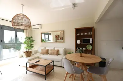 a living room with a white couch and a table at Beautiful apartment in Canet Playa by Hometels in Canet de Berenguer