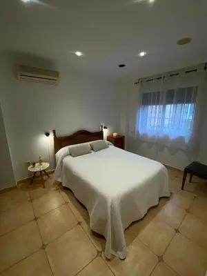a bedroom with a white bed and a window at Casa Rural Roa in Casinos