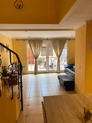 a living room with a couch and a large window at Casa Rural Roa in Casinos
