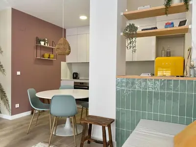 a kitchen with a table and chairs in a room at Casa Xava Valencia in Valencia
