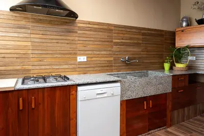 a kitchen with a sink and a stove in it at Cueva con jacuzzi a 20 minutos de Valencia in Benaguacil