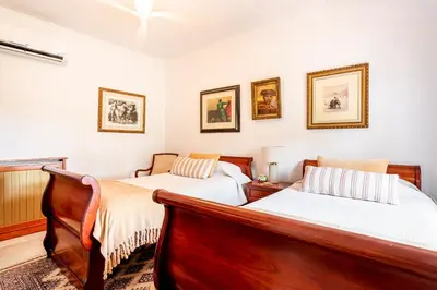 a bedroom with two beds and pictures on the wall at Casa para familias y grupos in Manises