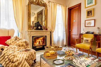 a living room with a fireplace and a table at Casa para familias y grupos in Manises
