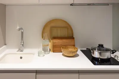 a kitchen counter with a sink and a pot on a stove at VLC HOST - Reino in Valencia