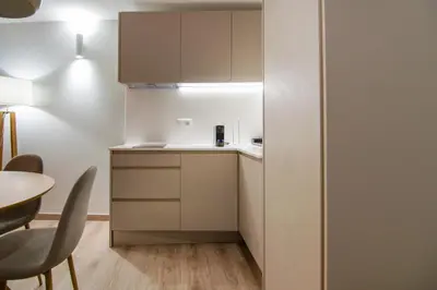 a small kitchen with white cabinets and a table at VLC HOST - Reino in Valencia