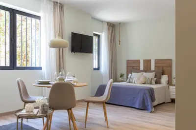 a bedroom with a bed and a table and chairs at VLC HOST - Reino in Valencia