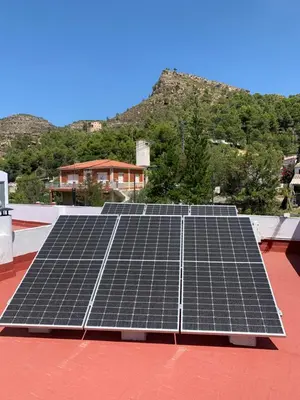 a group of solar panels on the roof of a house at DeCASTA in Chulilla