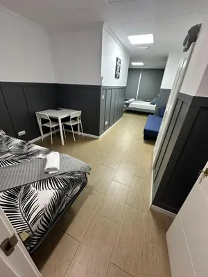 a room with a bed and a table and chairs at Optimus Comfort in Valencia