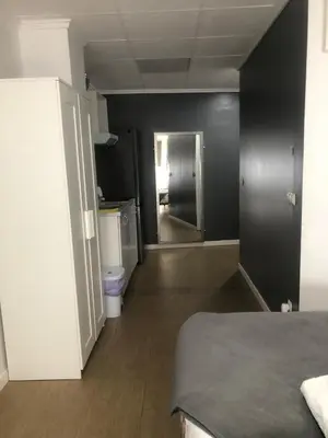 a room with a bed and a hallway with a bathroom at Optimus Comfort in Valencia