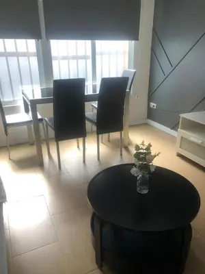 a dining room with a black table and chairs at Optimus Comfort in Valencia