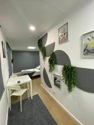 a room with a table and plants on the wall at Optimus Comfort in Valencia
