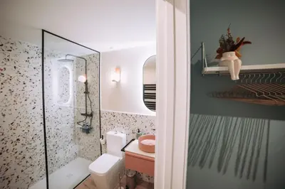 a bathroom with a toilet and a glass shower at Park Central loft. Ruzzafa. in Valencia