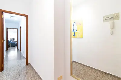 a mirror in a room with a hallway at Global Vacacional, Practico apartamento para 6 personas en Puerto Sagunto in Puerto de Sagunto