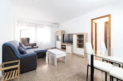 a living room with a couch and a table at Global Vacacional, Practico apartamento para 6 personas en Puerto Sagunto in Puerto de Sagunto