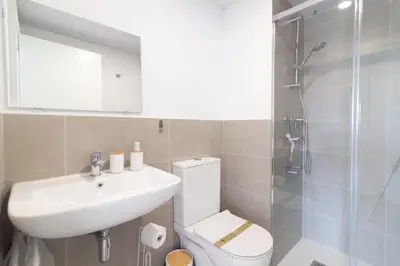 a bathroom with a toilet and a sink and a shower at Global Vacacional, Apartamento con 2 terrazas en Gran Canet in Canet de Berenguer