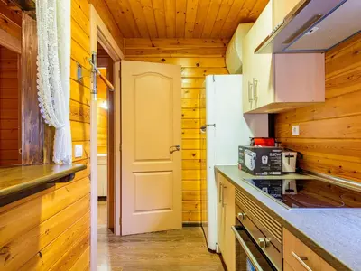 a kitchen with wooden walls and a white refrigerator at Holiday Home La Alqueria de Jordi by Interhome in El Grao