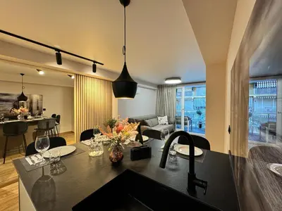 a kitchen and living room with a table and chairs at Luxury apartment Y after renovation in Cullera with parking in Cullera