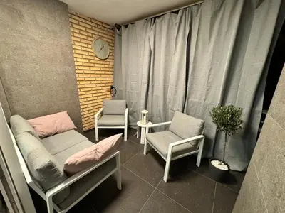 a room with two beds and two chairs and a window at Luxury apartment Y after renovation in Cullera with parking in Cullera