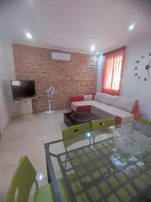 a living room with a couch and a glass table at Planta baja, bien comunicada, cerca de la playa. in Valencia