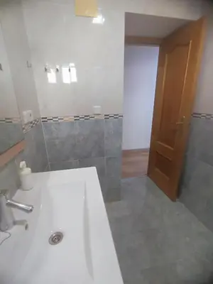 a bathroom with a sink and a toilet and a mirror at Planta baja, bien comunicada, cerca de la playa. in Valencia