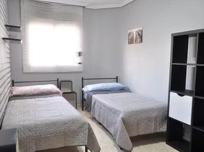 a room with two beds and a window at Acogedor apartamento en Burriana centro in Burriana