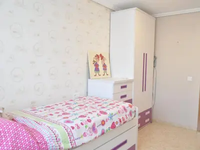 a small bedroom with a bed and a dresser at Acogedor apartamento en Burriana centro in Burriana