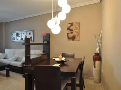 a living room with a table and a couch at Acogedor apartamento en Burriana centro in Burriana